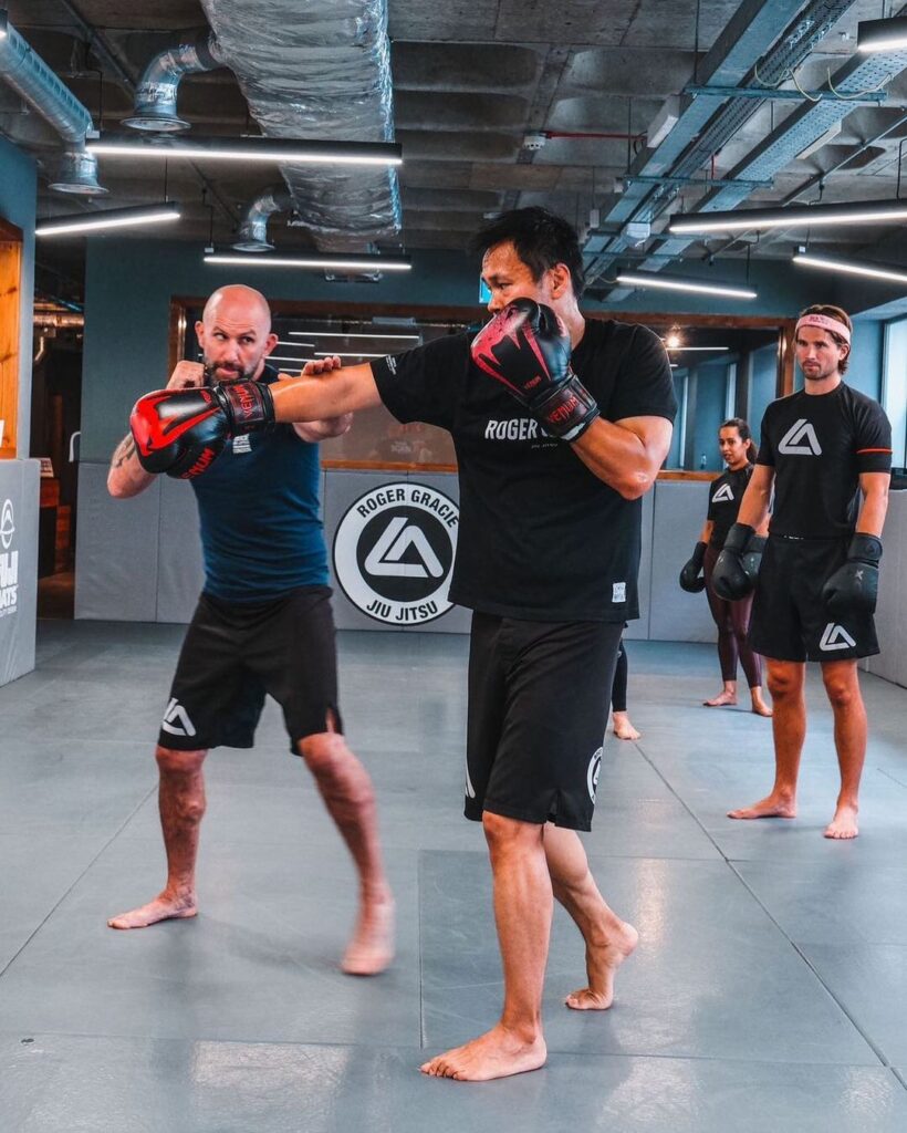 a instructor showing a student how to box